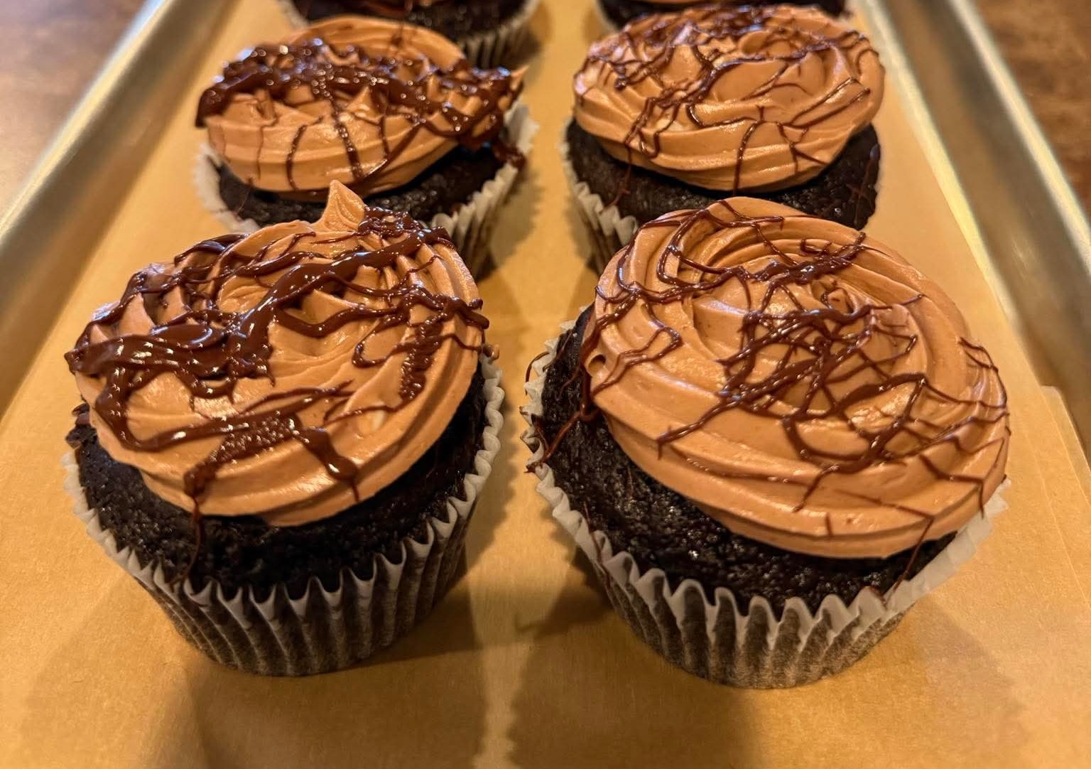 Chocolate cupcakes filled with raspberry and chocolate Swiss meringue buttercream...