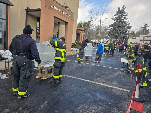 Firefighters with the Newton-Ransom Volunteer Fire Company test their skills as ice carvers at a previous Clarks Summit Ice Festival. (CHAD SEBRING/STAFF PHOTO)