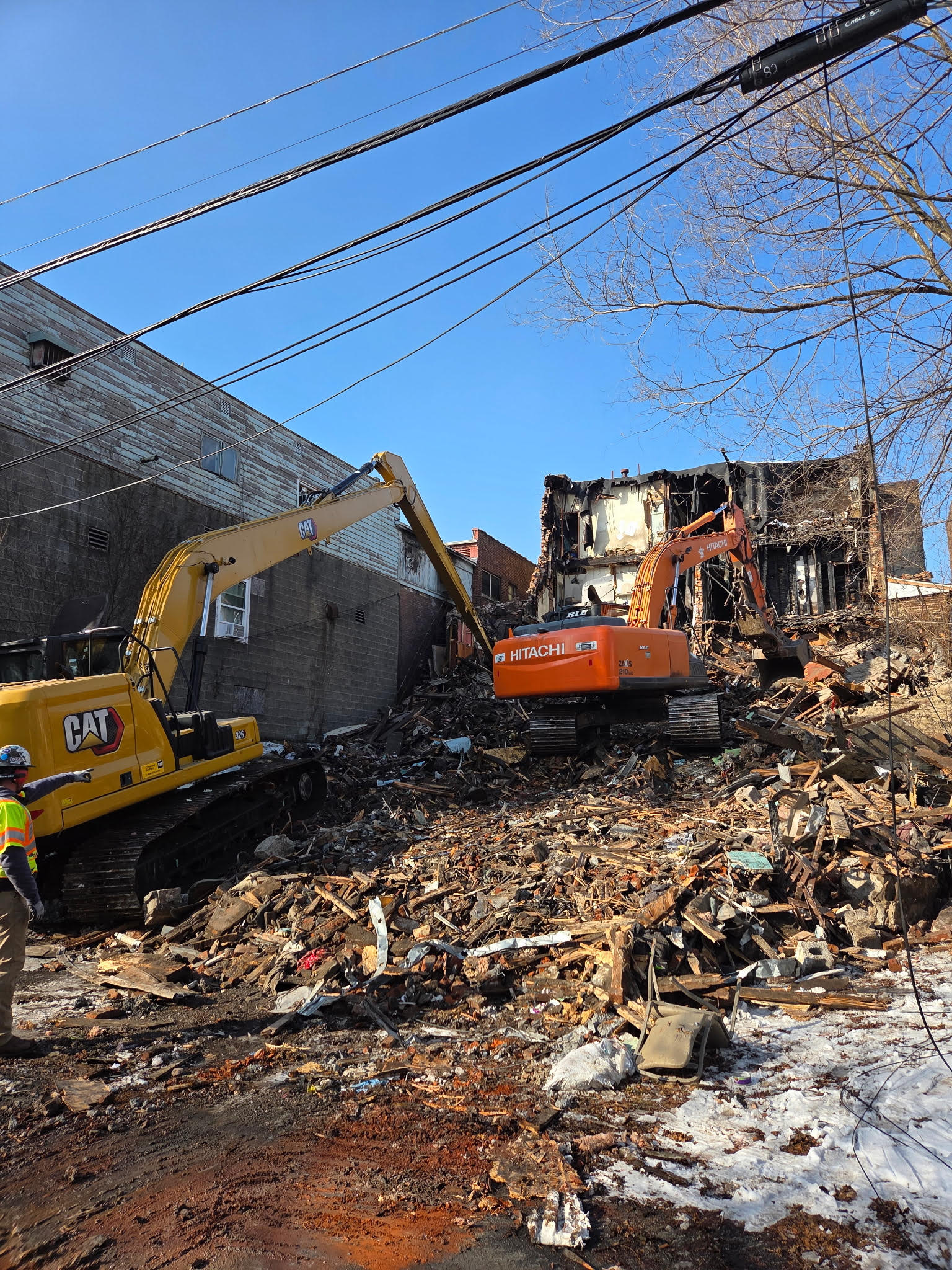 Crews from RLE Enterprises demolish a portion of the West...