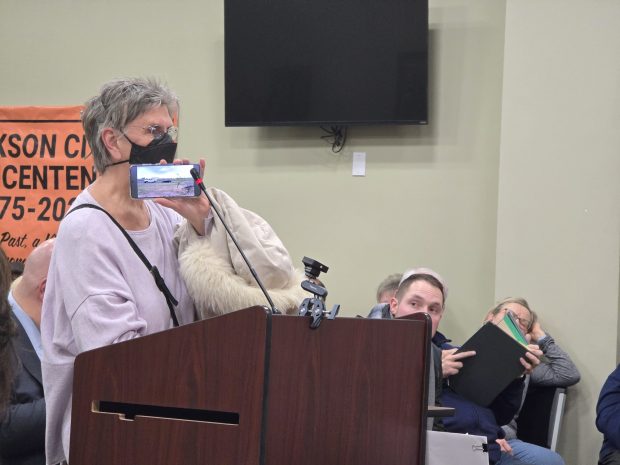 Dickson City resident Sheila Carluccio plays a video of what a data center sounds like during a public hearing Tuesday, Jan. 20, 2026, in the Dickson City Borough Building. (FRANK WILKES LESNEFSKY / STAFF PHOTO)