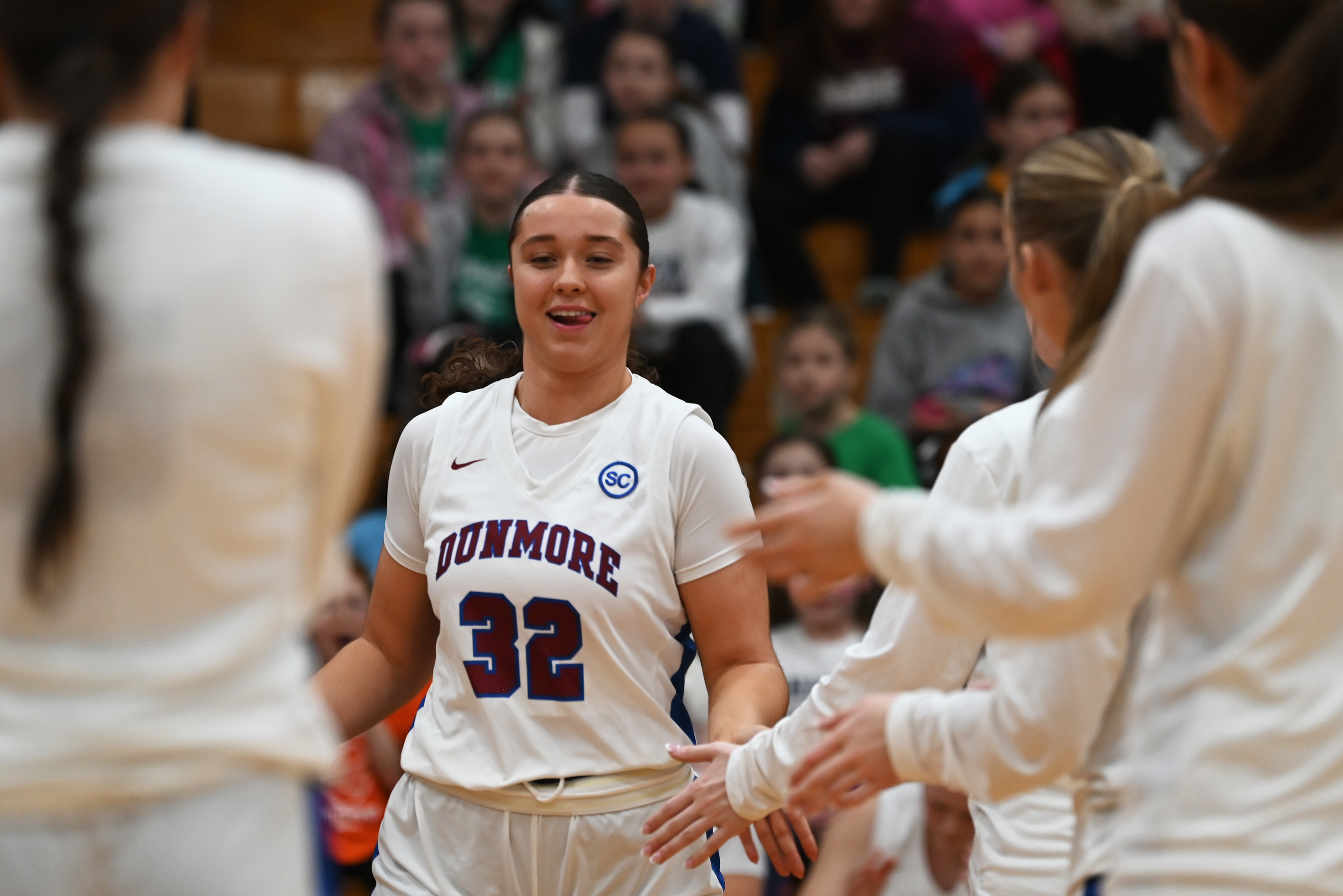 Dunmore’s Michelle Nidoh high fives teammates as she runs onto...