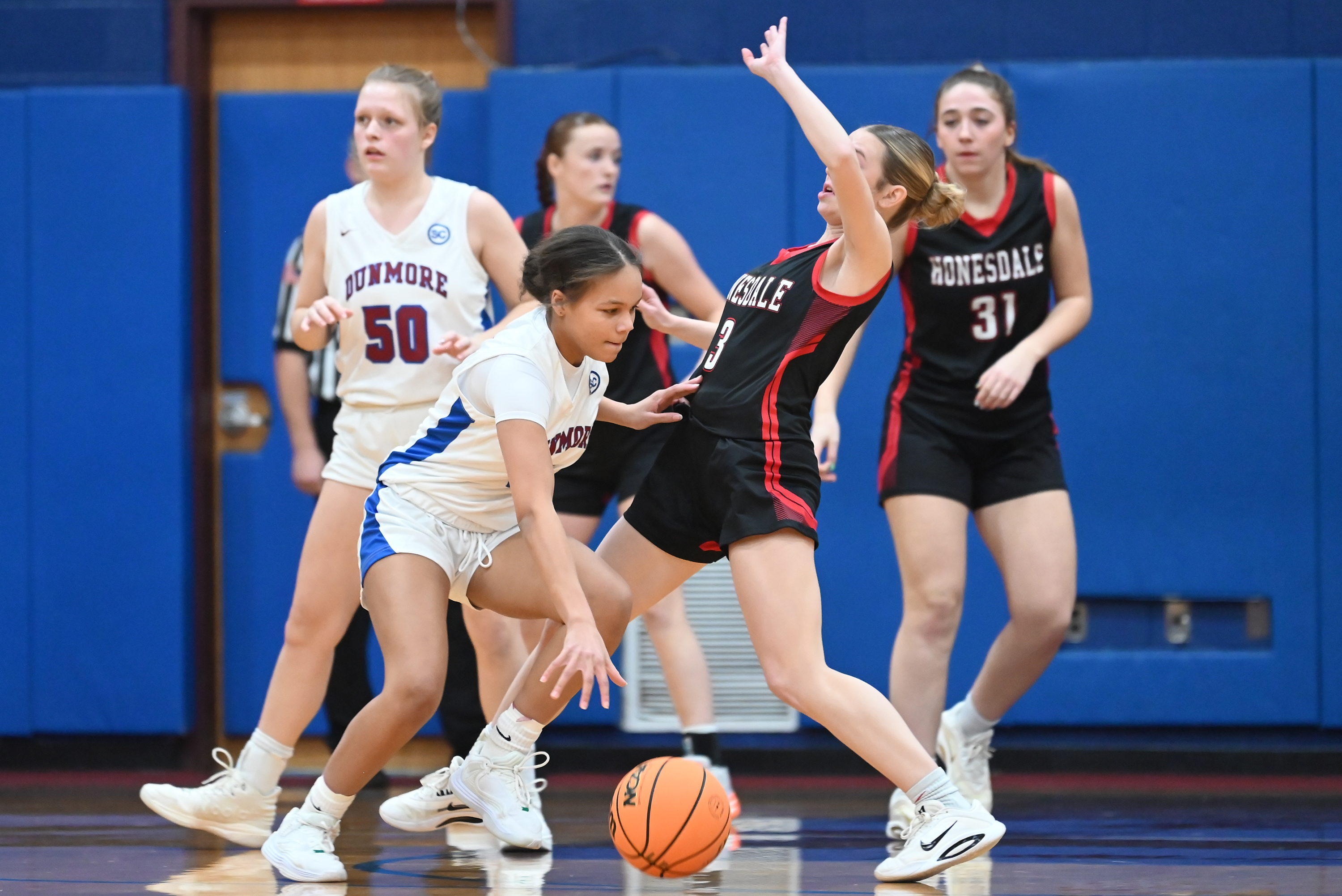 Dunmore’s Janessa Martin pushes past Honesdale’s Karsyn Kromko during the...