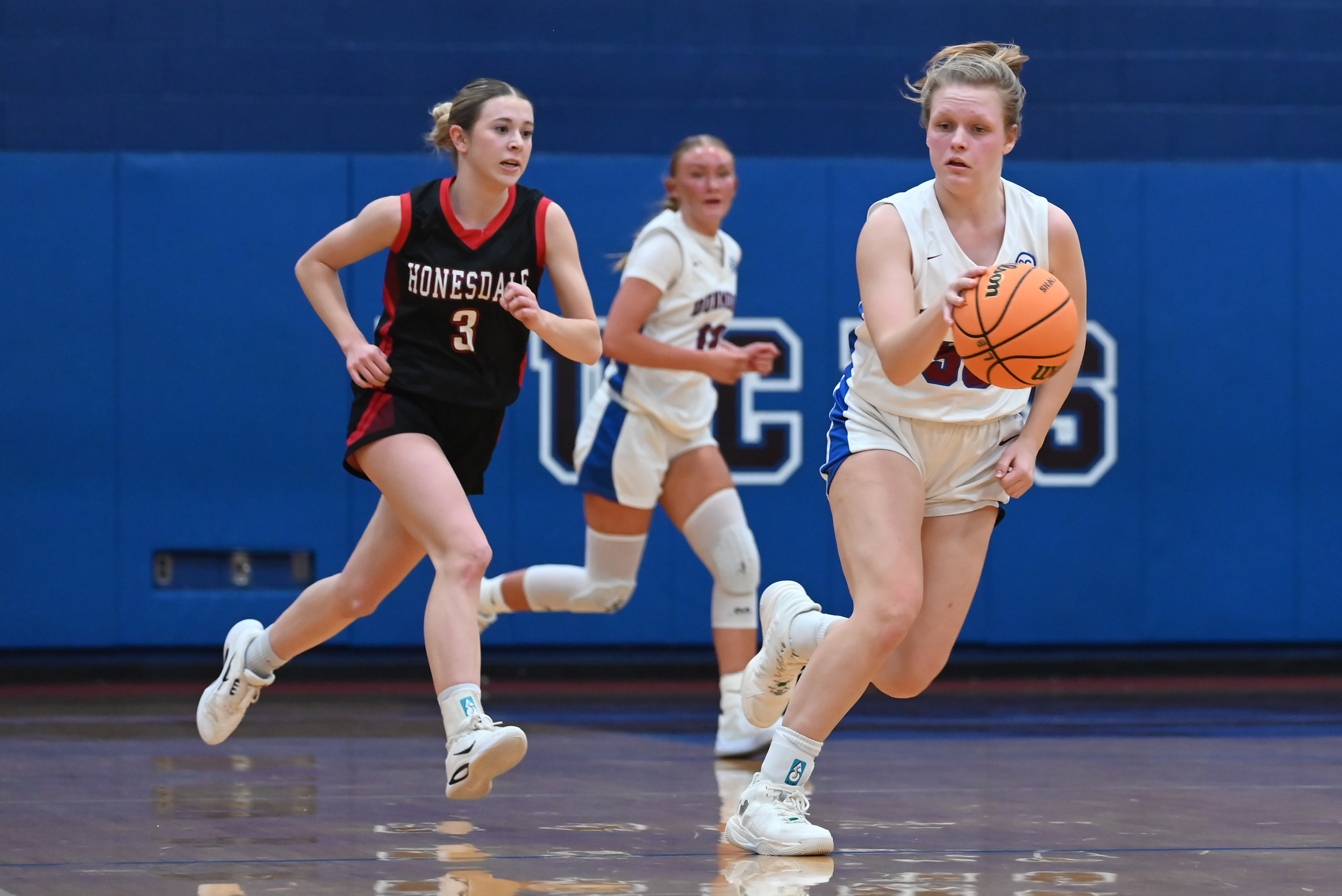 Dunmore’s Jackie Brown moves the ball during the basketball game...