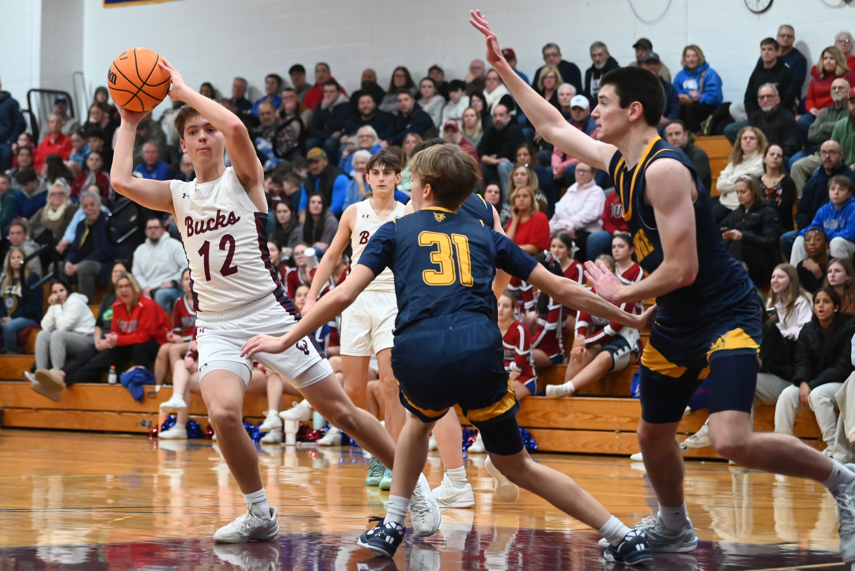 Dunmore’s Jimmy Clark controls the ball during the basketball game...