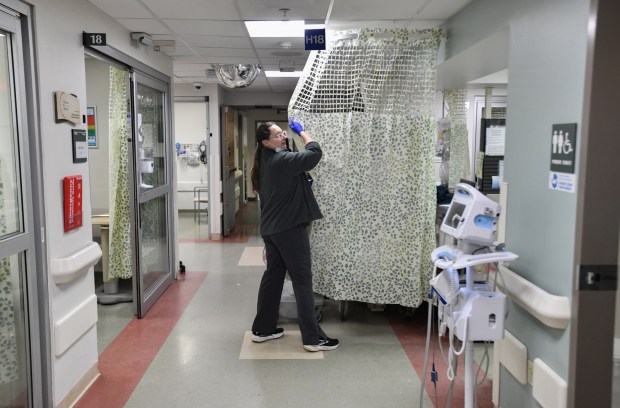 Registered nurse Natalie Wojtak closes the curtain to create privacy for a patient in the emergency room at Geisinger Community Medical Center in Scranton Friday, January 16, 2026. (SEAN MCKEAG / STAFF PHOTOGRAPHER)