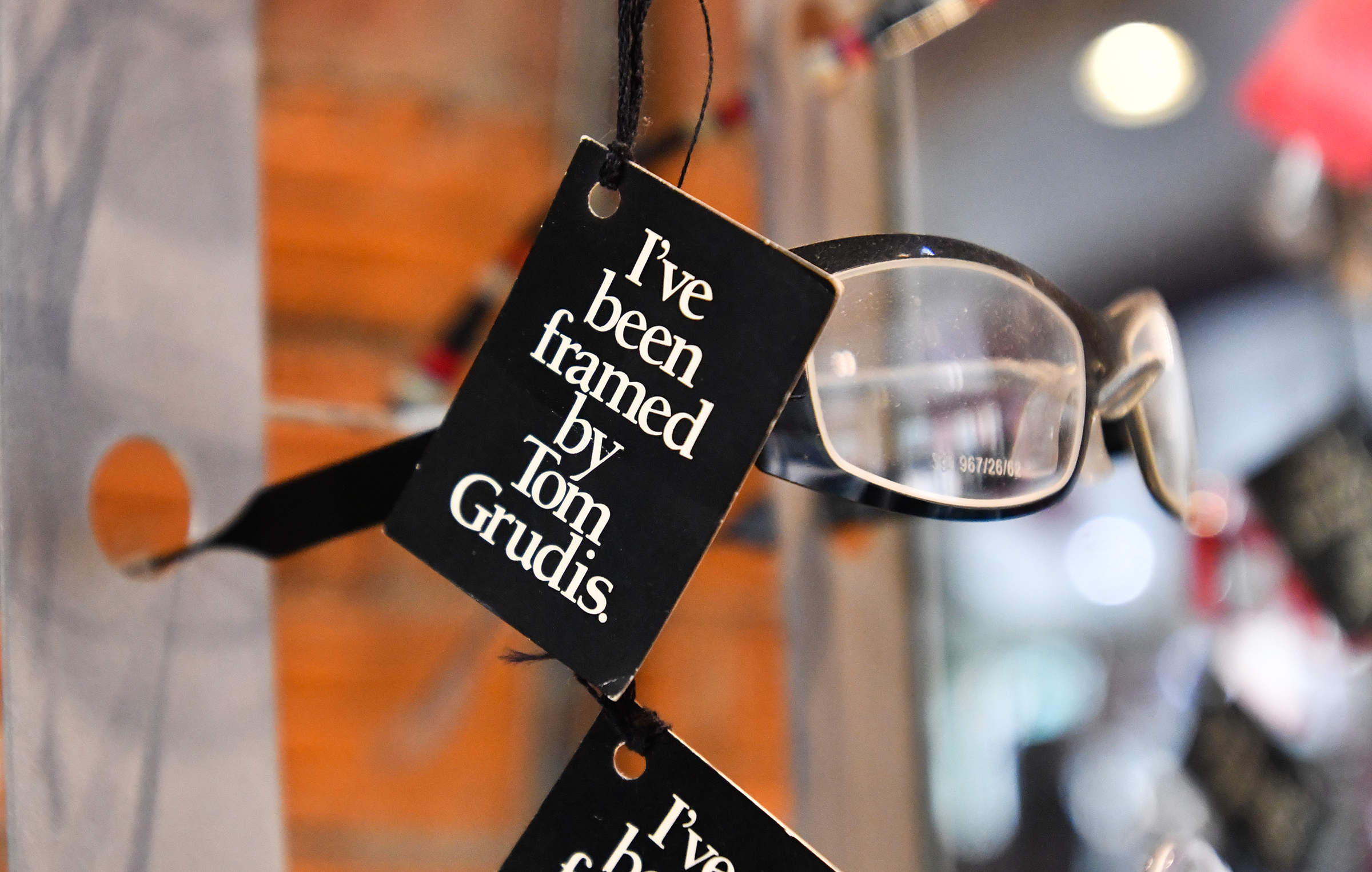 A tag is attached to eyeglasses sold at Tom Grudis...