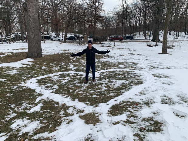 Frank Dubas stands inside of a large snow heart that someone made on the grounds of the Everhart Museum at Nay Aug Park in Scranton, on Thursday, Jan. 22, 2026. The snow heart appears to have been inspired by a nearby display of red valentine hearts that Dubas placed outside of the museum. (JIM LOCKWOOD / STAFF PHOTO)