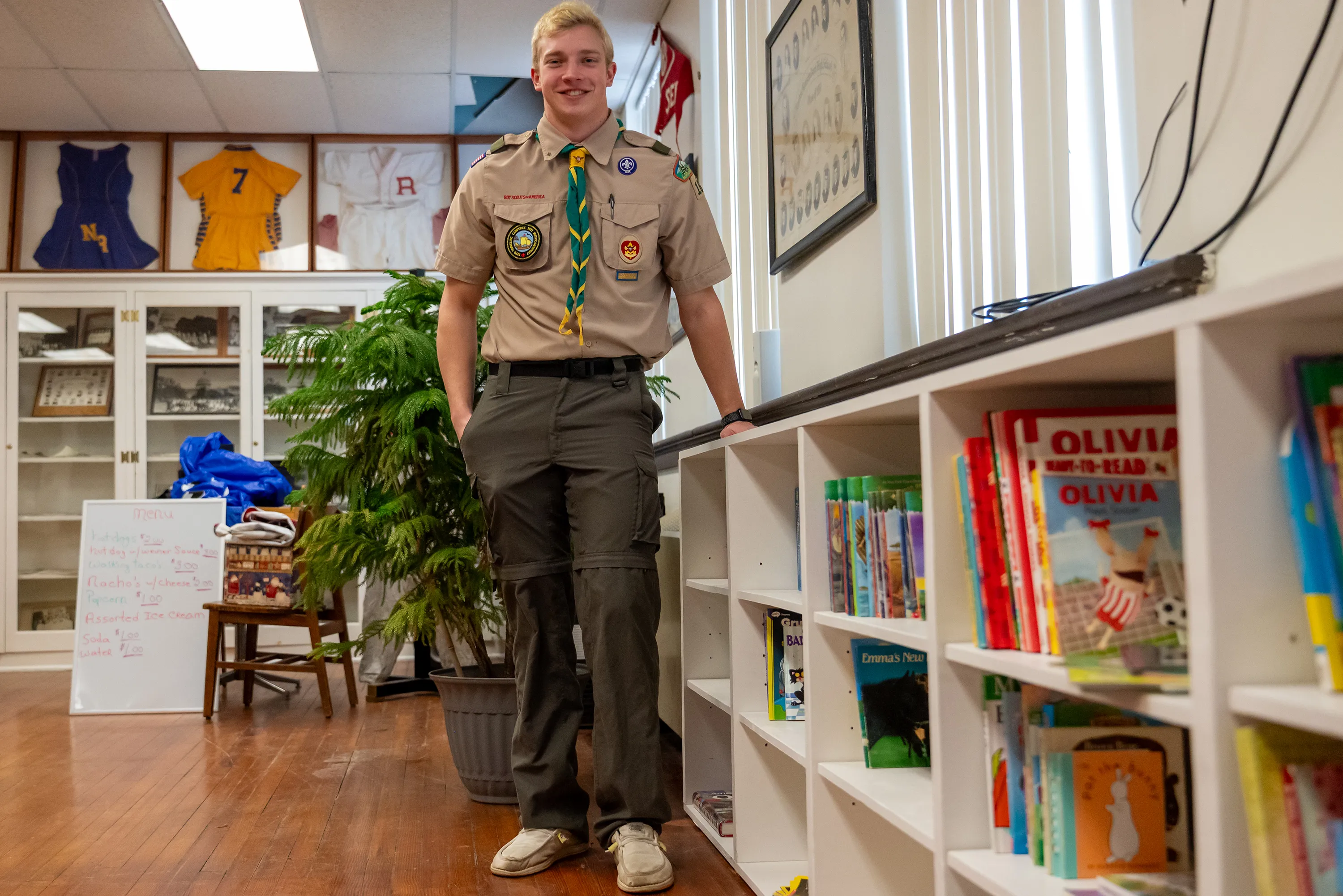 Boy Scout Derek Williams Newton stands next to the children’s...
