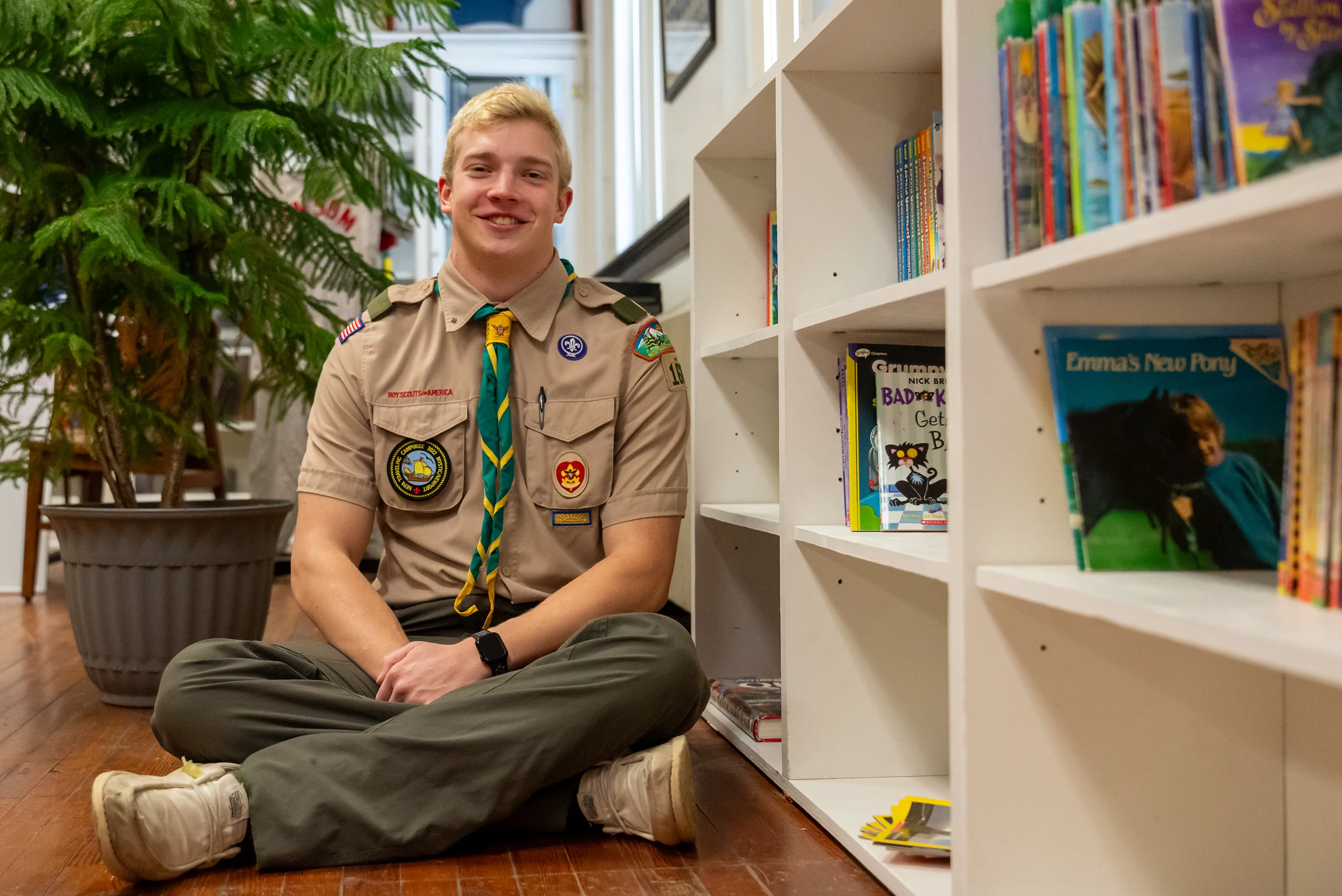 Boy Scout Derek Williams Newton sits next to the children’s...