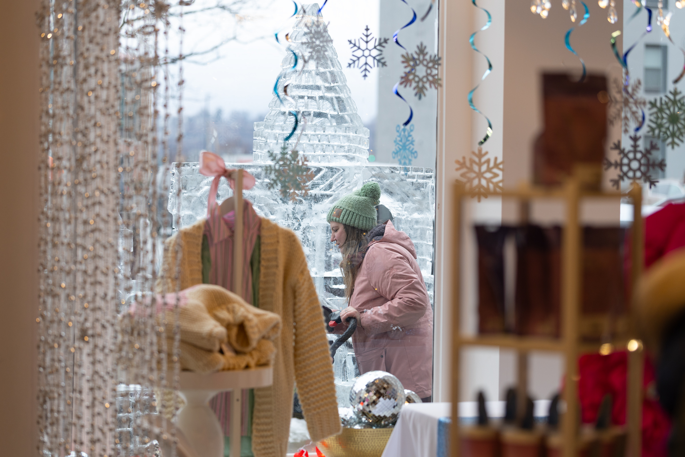 A person walks past an ice sculpture outside Penn House...
