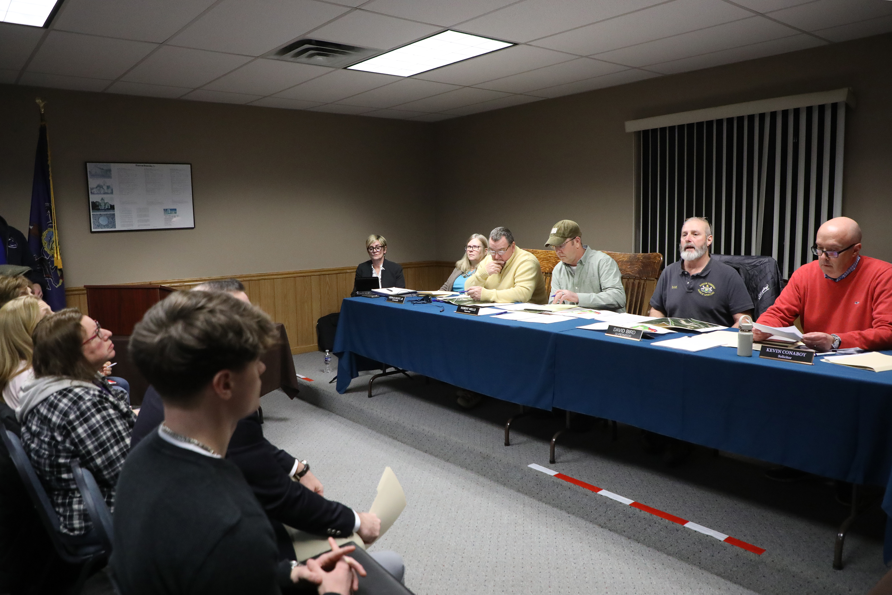 Board members start the Ransom Twp. zoning hearing meeting at...