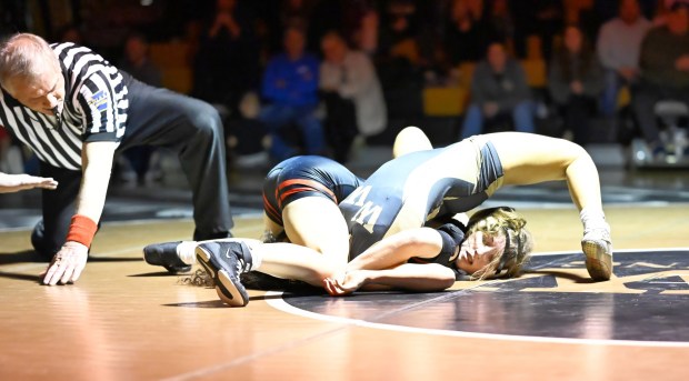 Honesdale's Saige Olver pins Western Wayne's Katelyn Nunez in the 124-pound match Friday night at Western Wayne. JESSE CAREY / CONTRIBUTING PHOTO