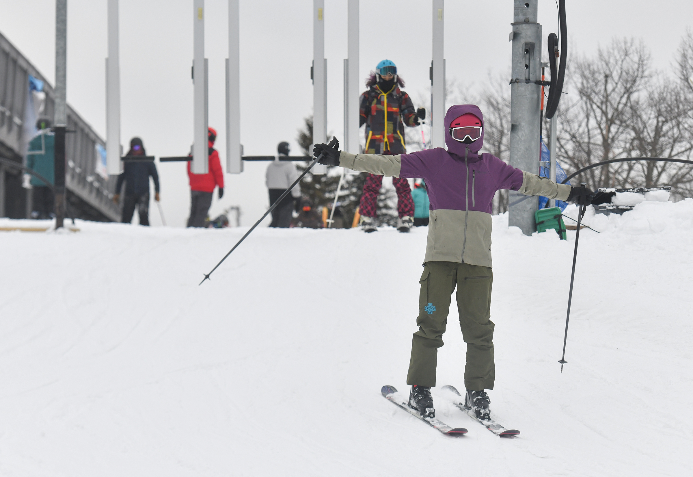 A skiier passes through the gate to ride the ski...