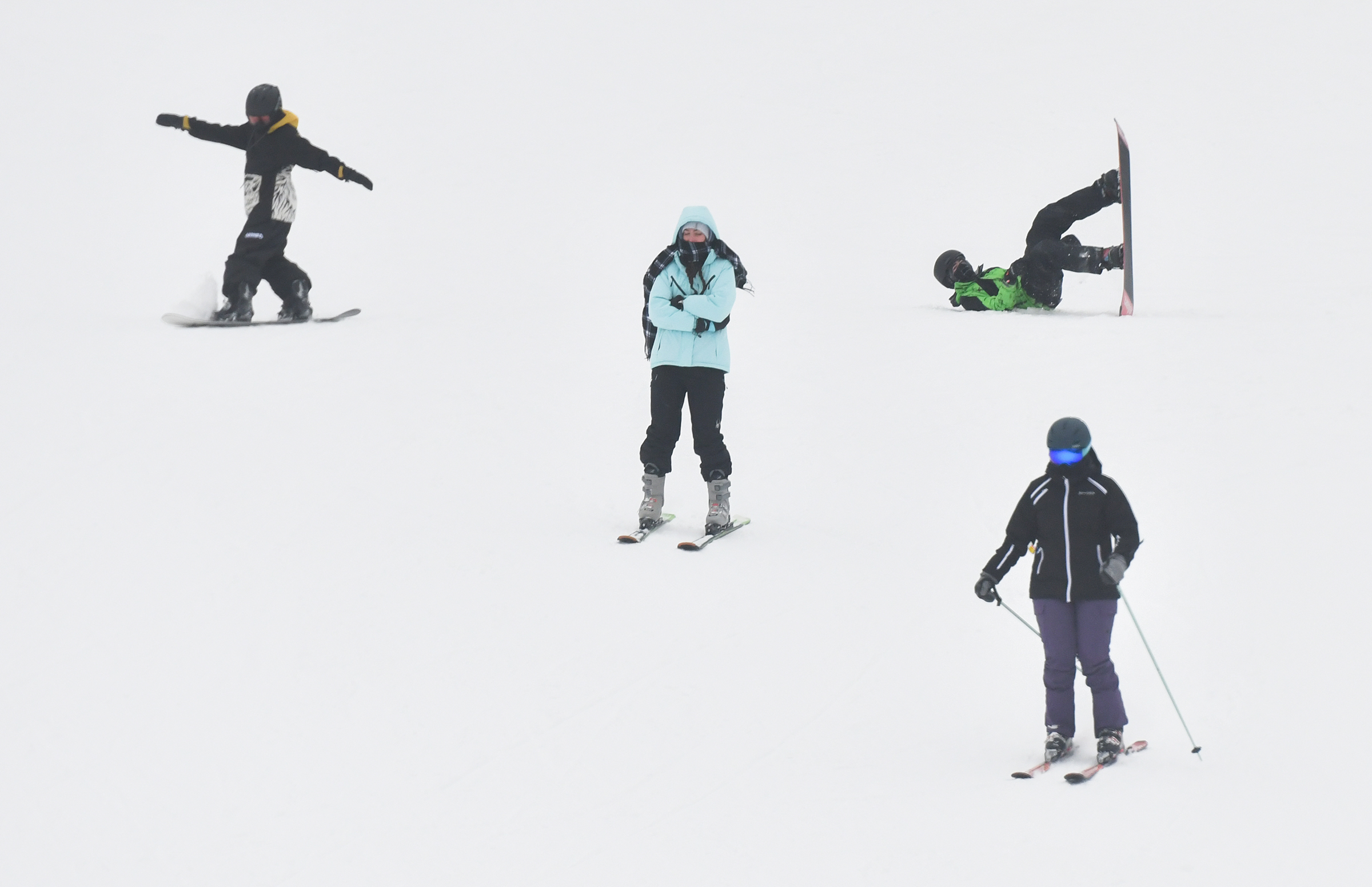 Skiiers and snowboarders ride down the slope at Montage Mountain...