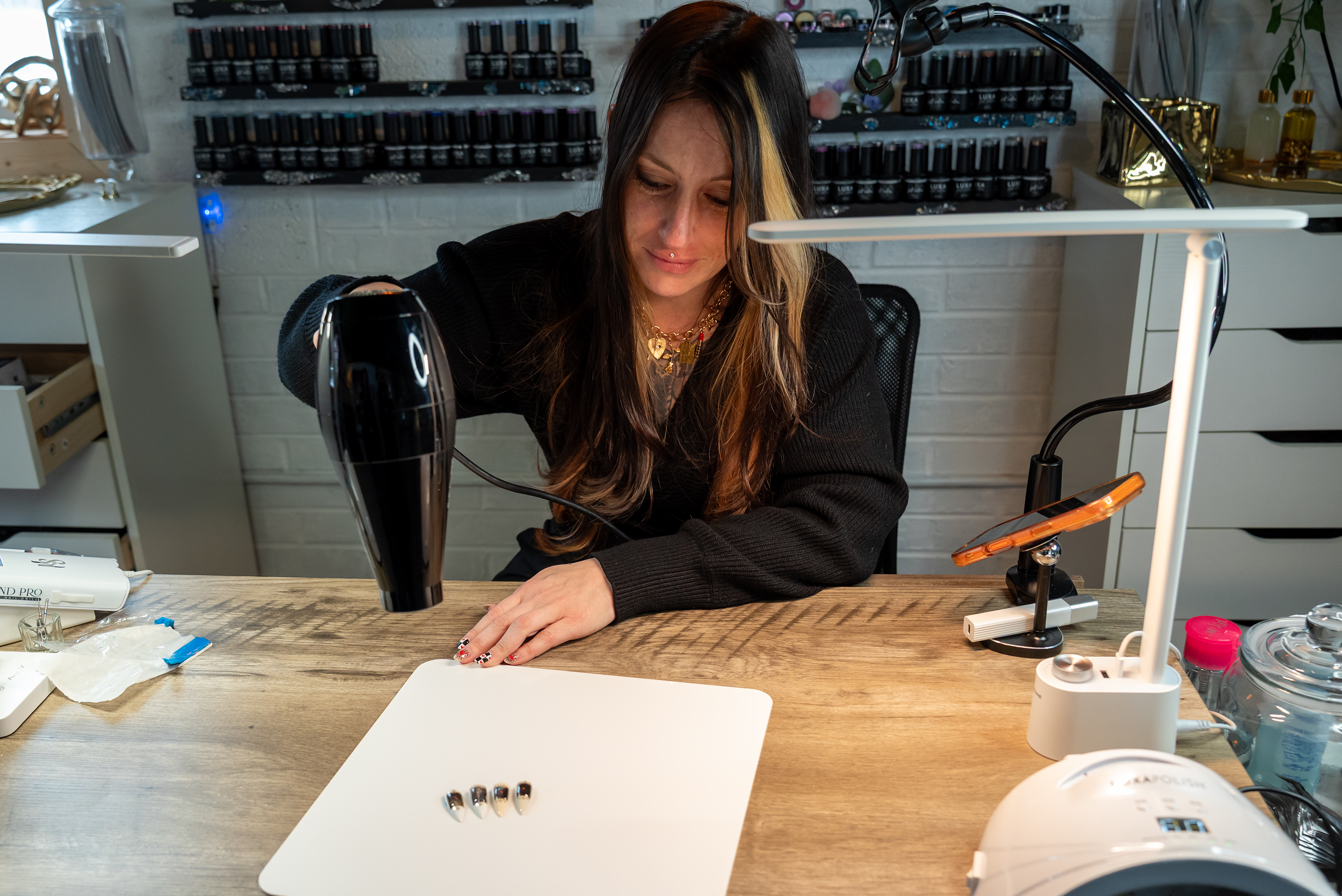 Artist Heather Buzzell applies heat to reveal the imagery on...