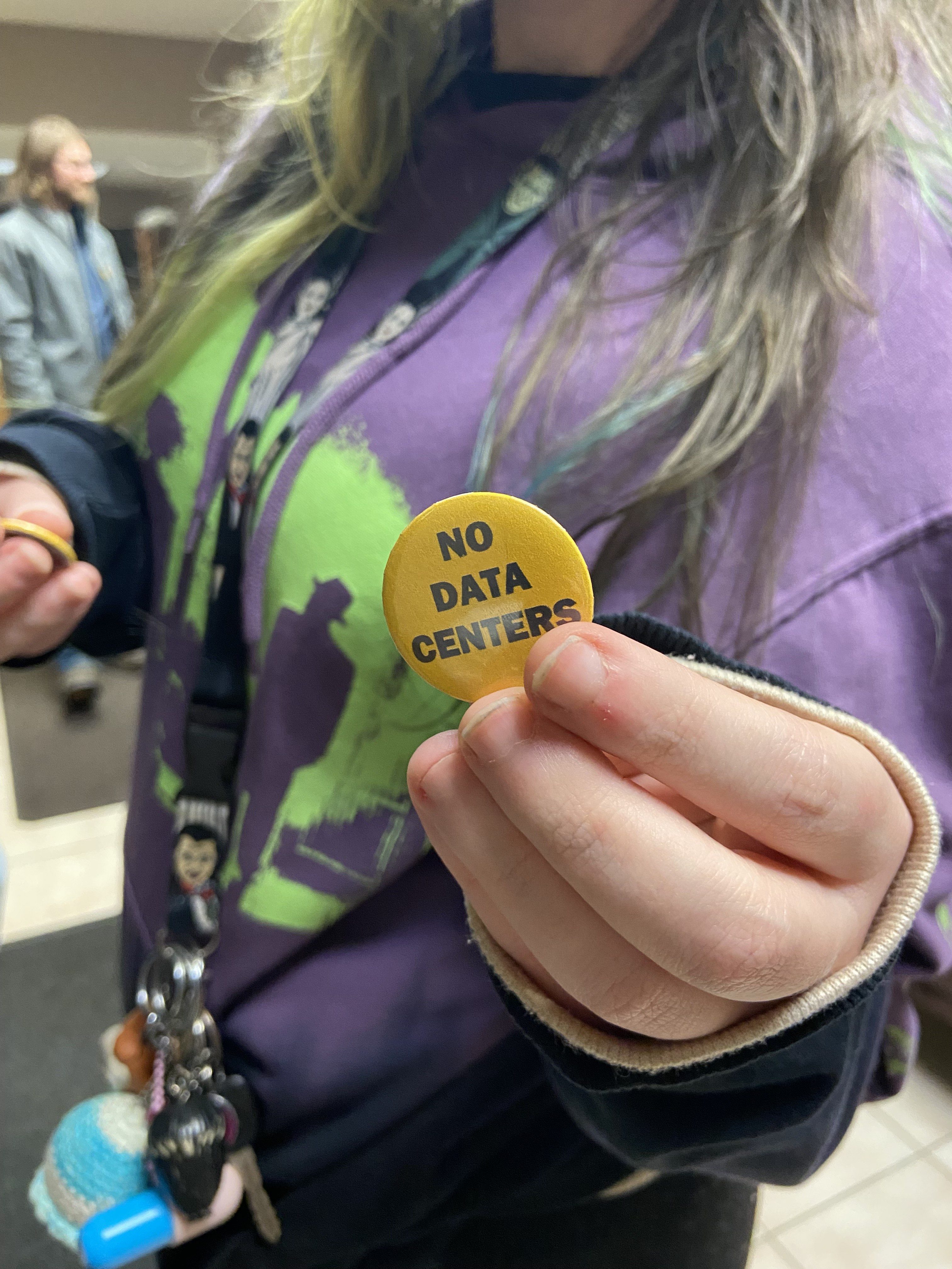 Scranton resident Hayley Schaffer shows a “no data centers” pin...