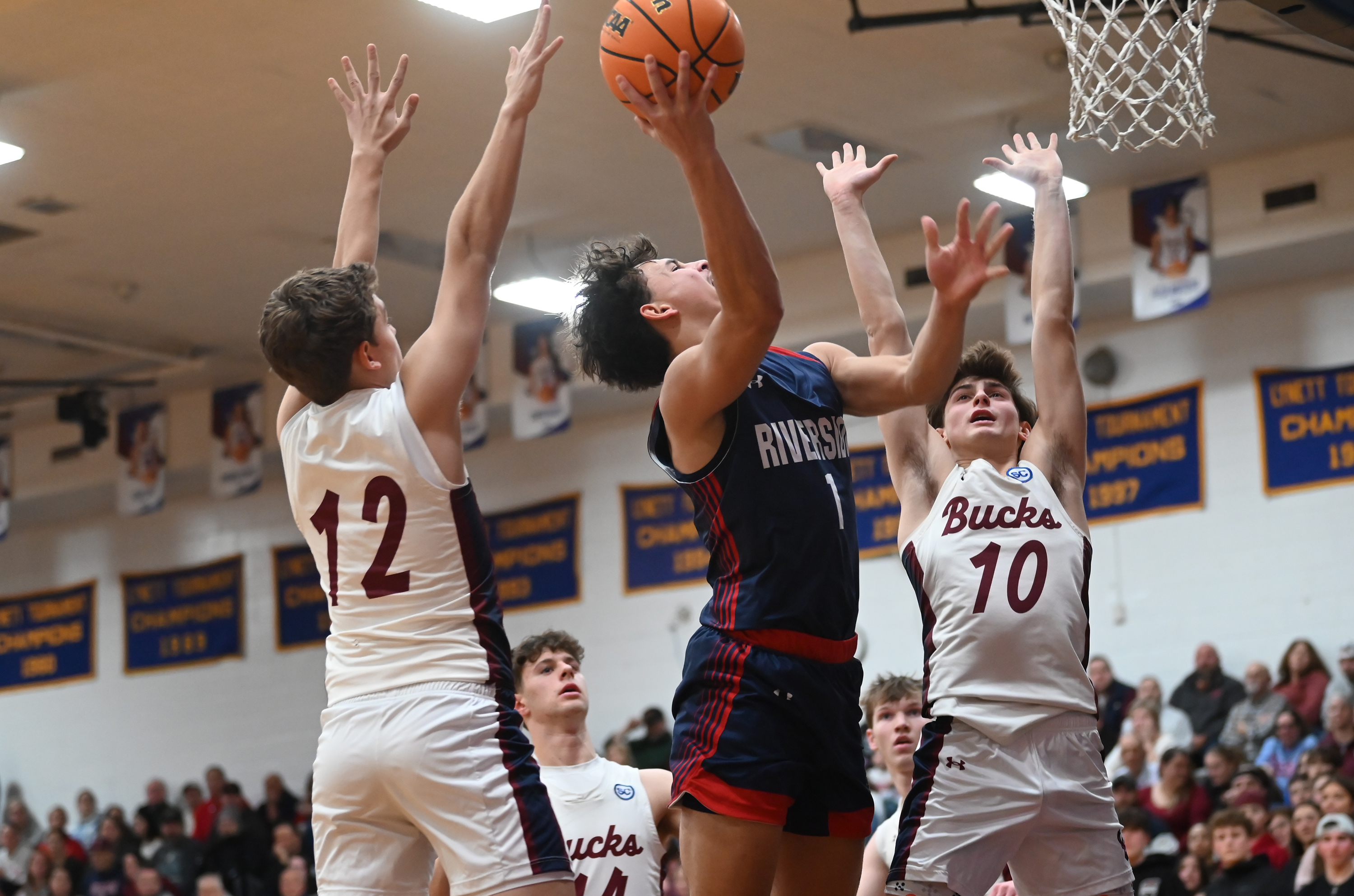 Riverside’s Brayden Rose goes up for a shot between Dunmore’s...