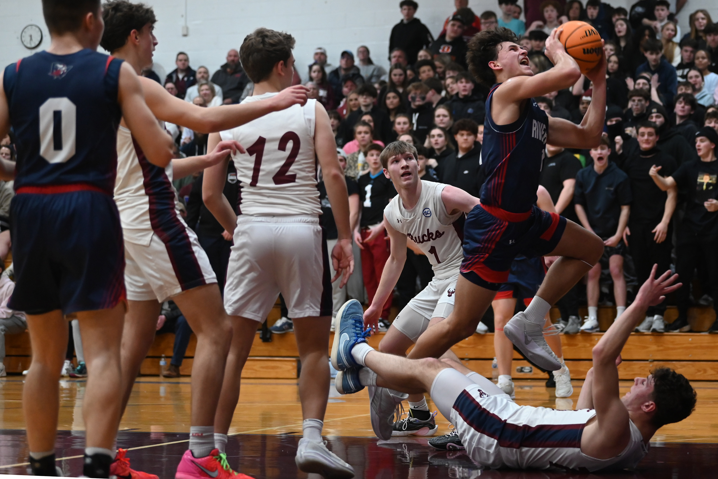 Riverside’s Brayden Rose jumps toward the hoop during the game...
