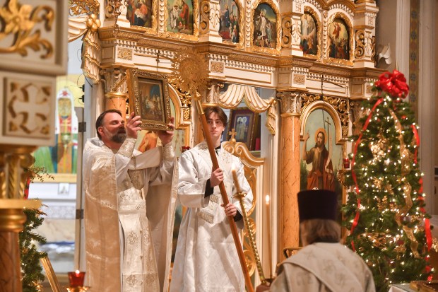 Father Nathaniel Sorochka holds up the Nativity icon during the Eve of the Nativity of Christ at St. John's Russian Orthodox Cathedral in Mayfield Tuesday, January 6, 2026. (SEAN MCKEAG / STAFF PHOTOGRAPHER)