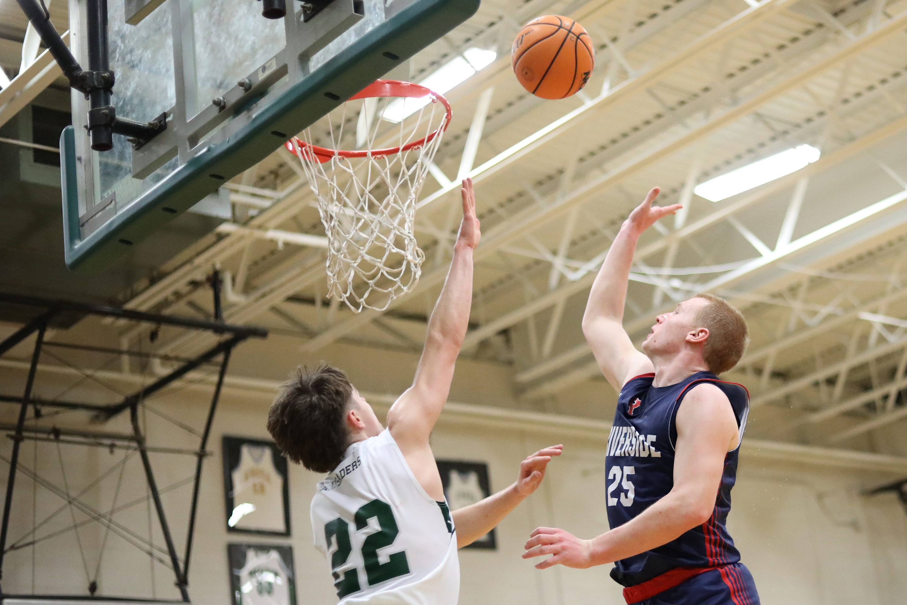 Holy Cross’ Jack Alpert defends Riverside’s Jared Jackson during the...