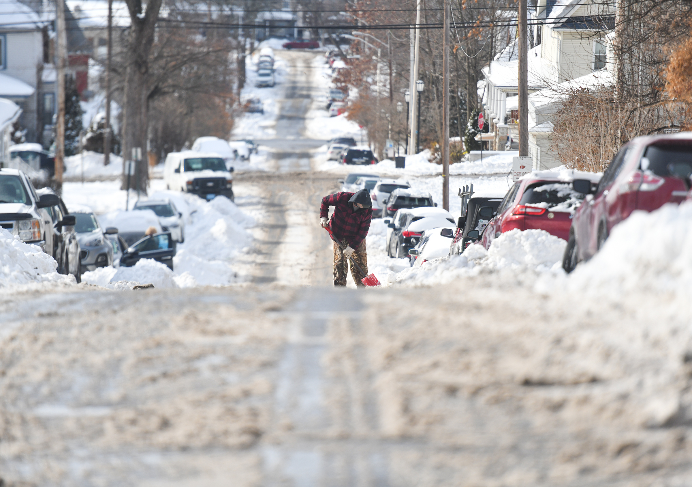 A resident of Scranton’s Hill Section shovels his car out...
