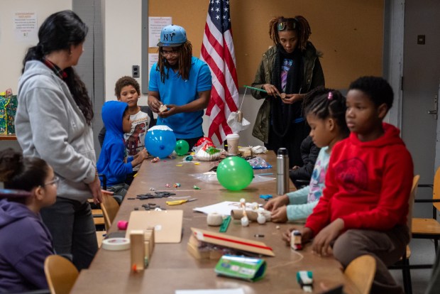 Students and their families build Rube Goldberg machine for the Reach Cyber Charter School's winter STEM challenge at the Electric City Trolley Museum in Scranton on Wednesday, Jan. 14, 2026. (REBECCA PARTICKA/STAFF PHOTOGRAPHER)