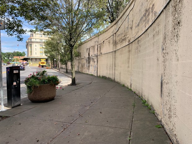 A circa-1908 retaining wall along Lackawanna Avenue near the Radisson Lackawanna Station Hotel in downtown Scranton on Tuesday, Aug. 19, 2025. A Scranton streetscape project will repair the 120-foot-long wall. (JIM LOCKWOOD / STAFF PHOTO)