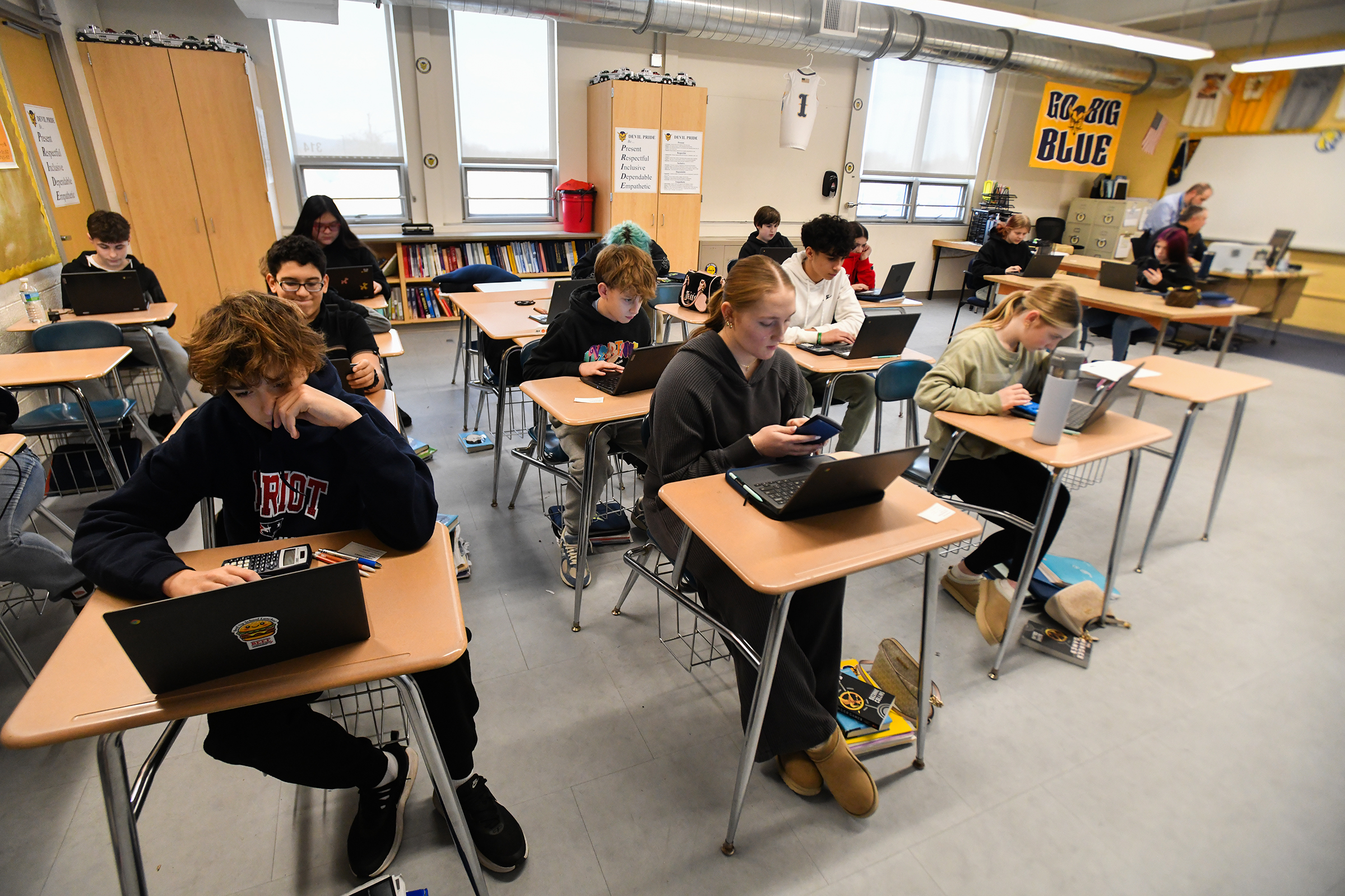 Eighth grade students take a pre-algebra benchmark assessment test in...