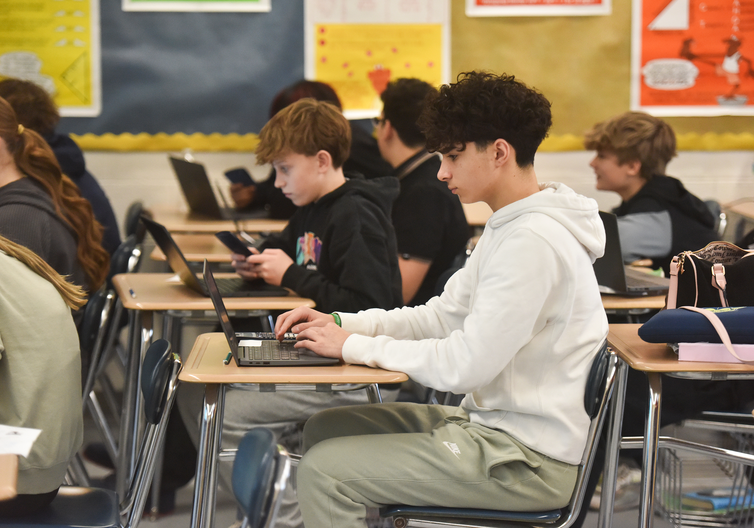 Eighth grade students take a pre-algebra benchmark assessment test in...