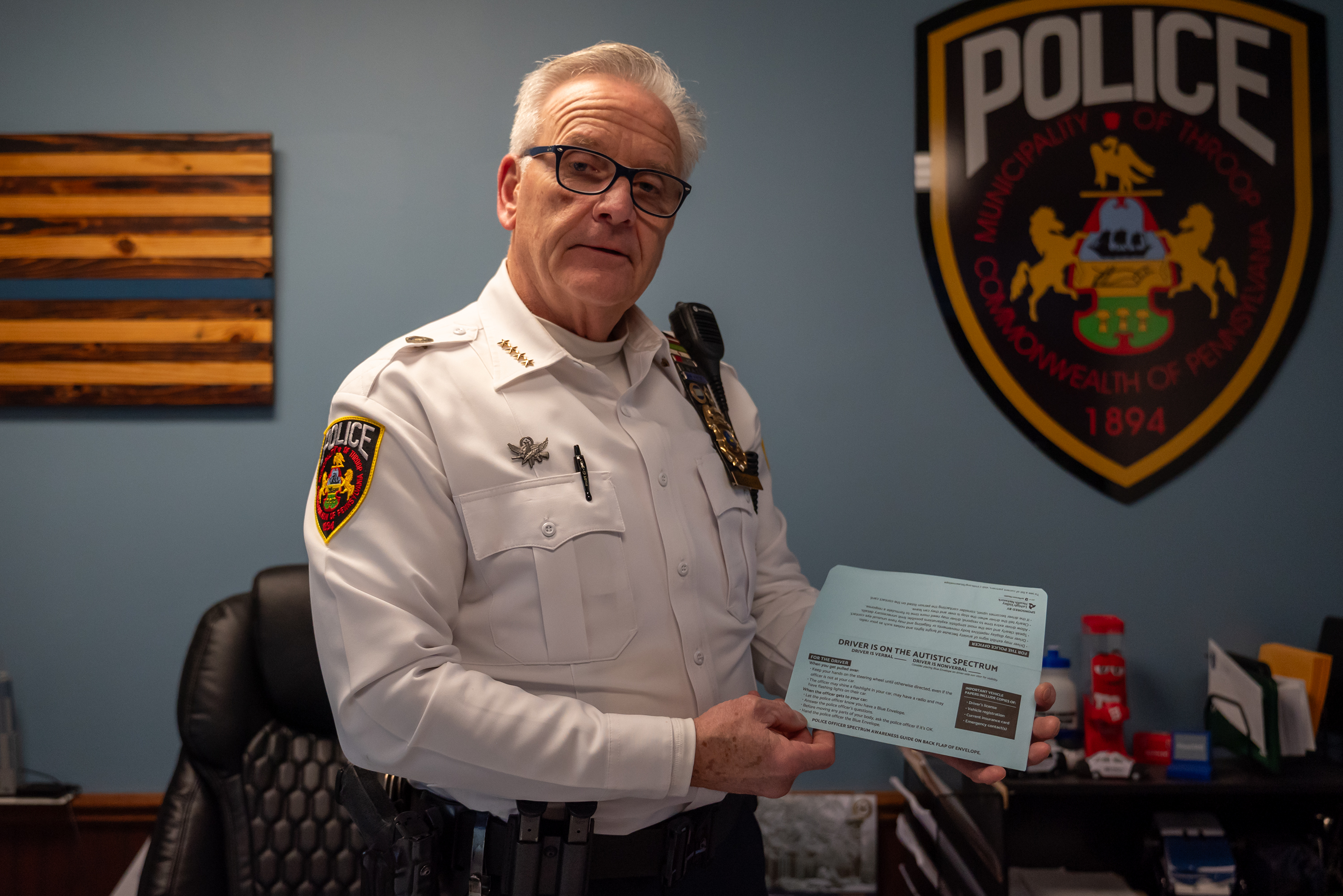 Chief of Police Andrew Kerecman holds a blue envelope at...