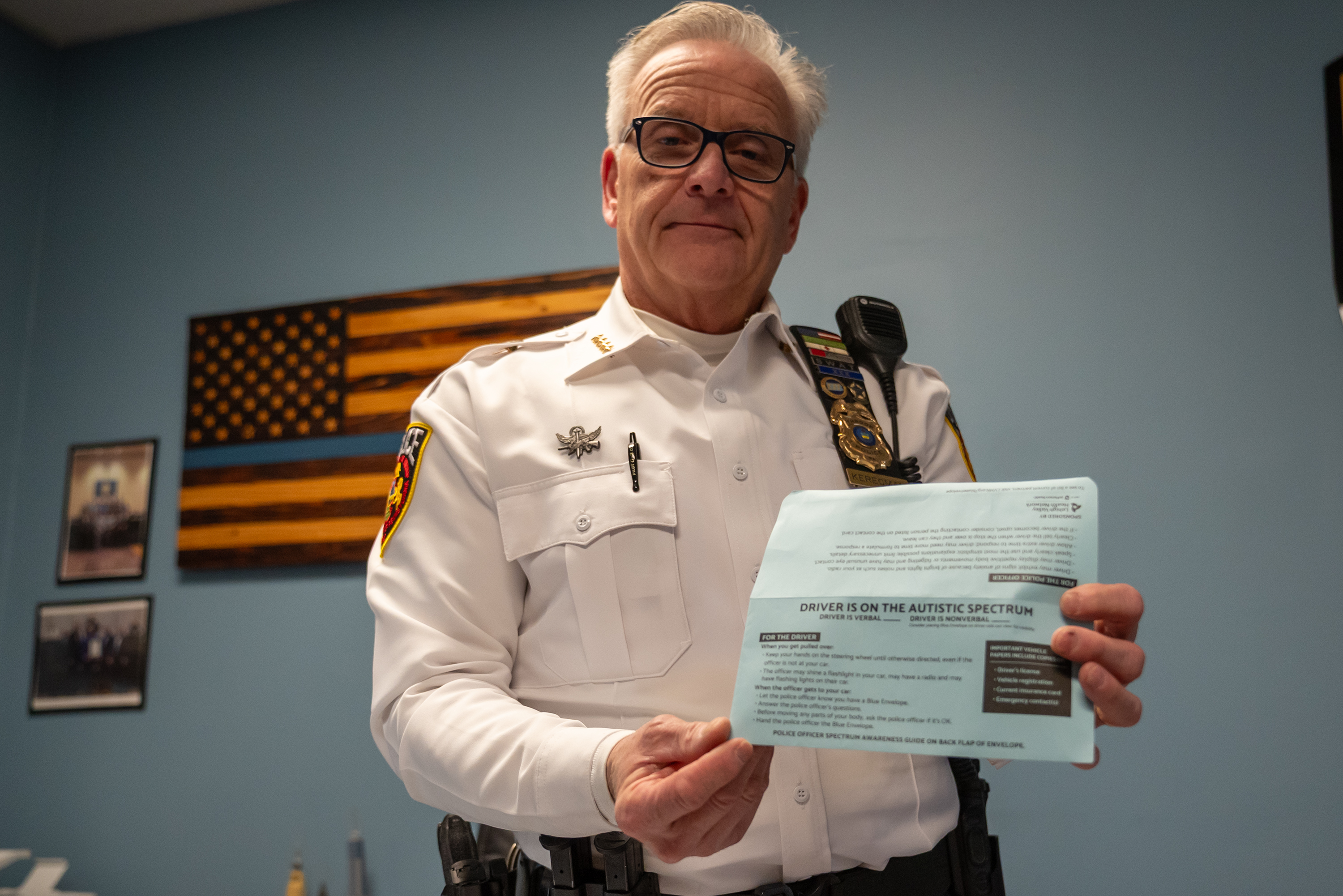 Chief of Police Andrew Kerecman holds a blue envelope at...