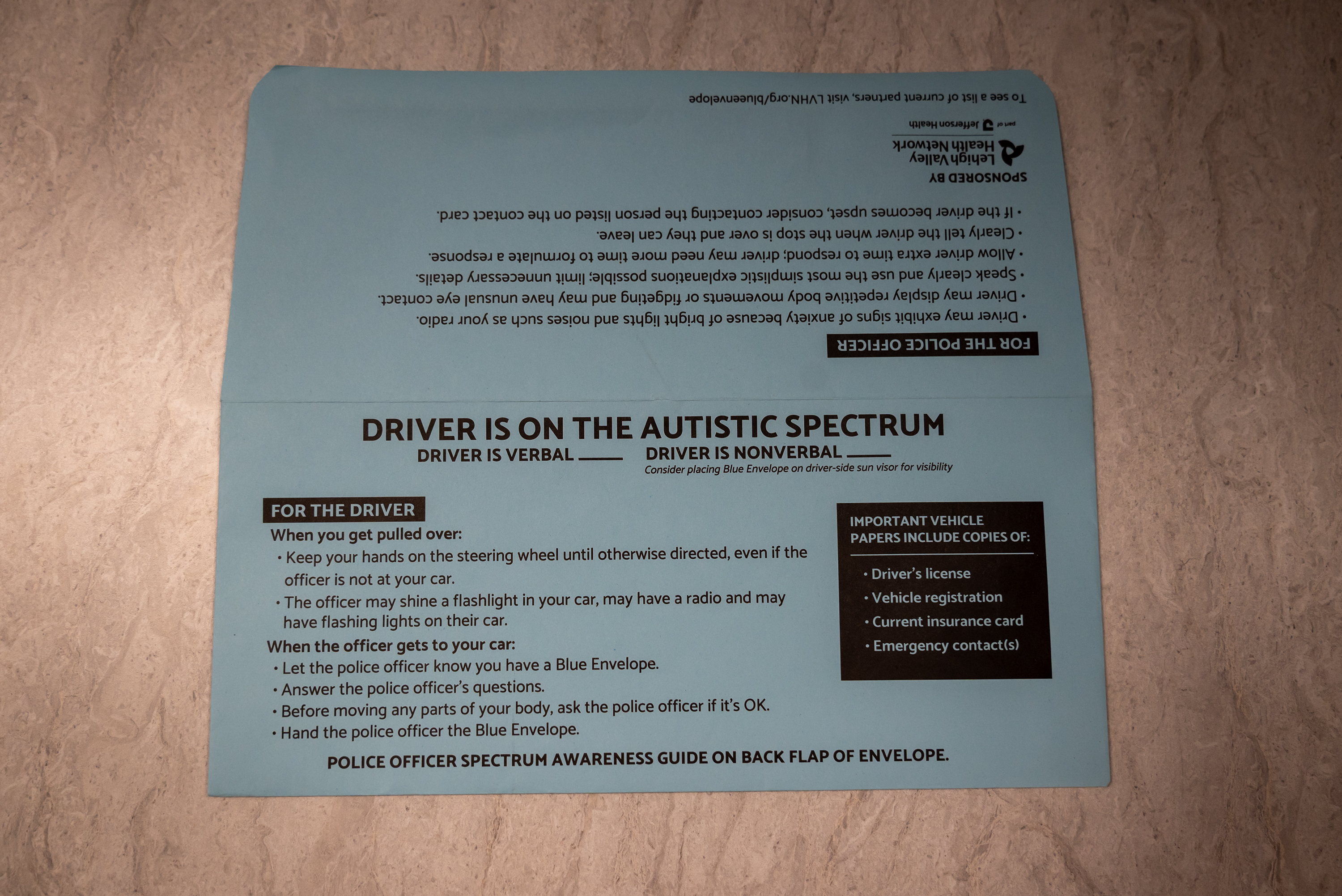 A blue envelope on a desk at the Throop Police...