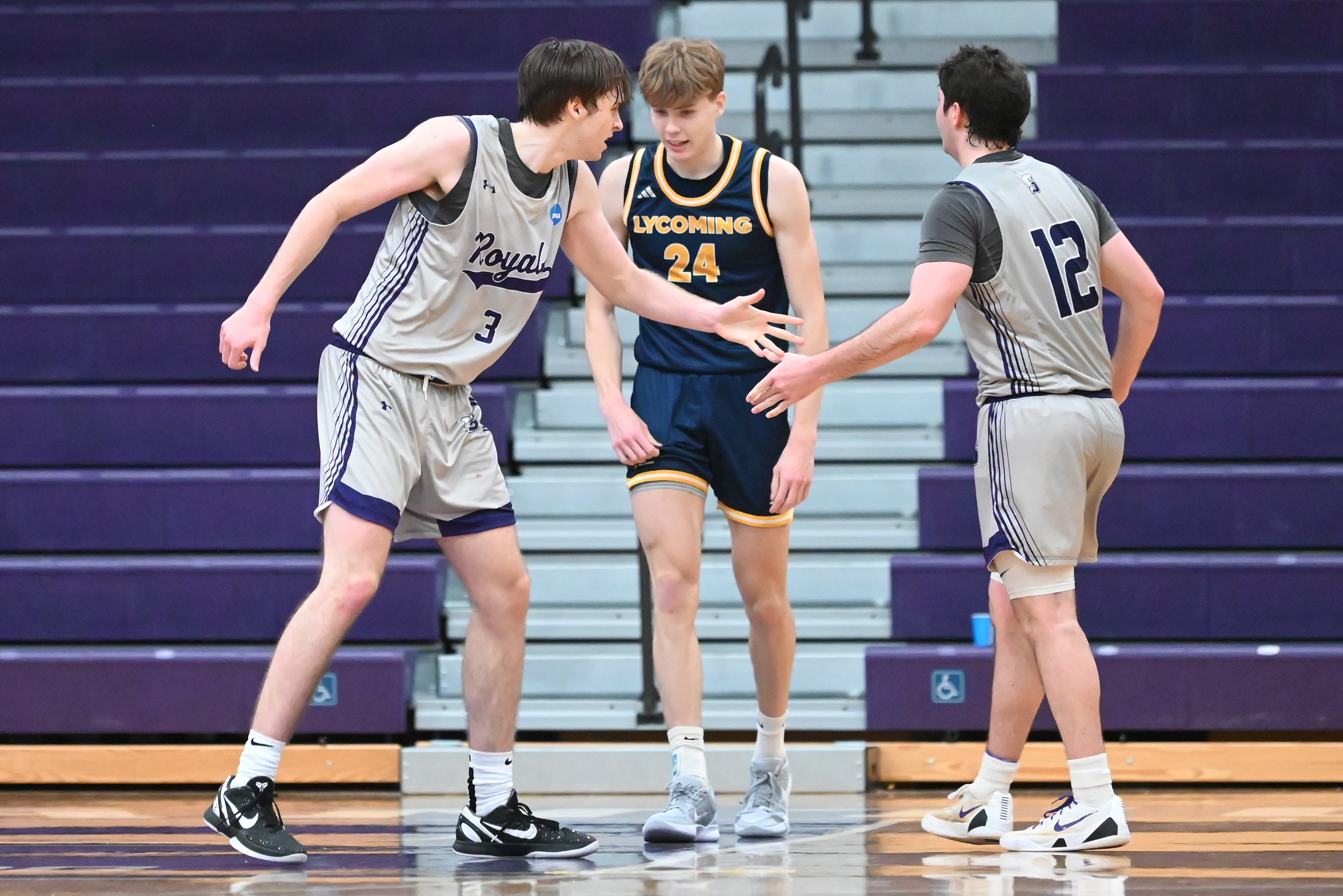 University’s Sammy Tornabene shares a high five with his teammate...