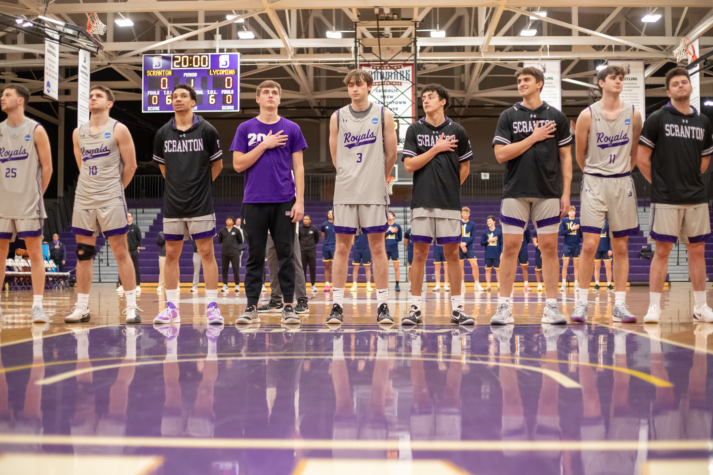 University of Scranton players stand for the national anthem before...