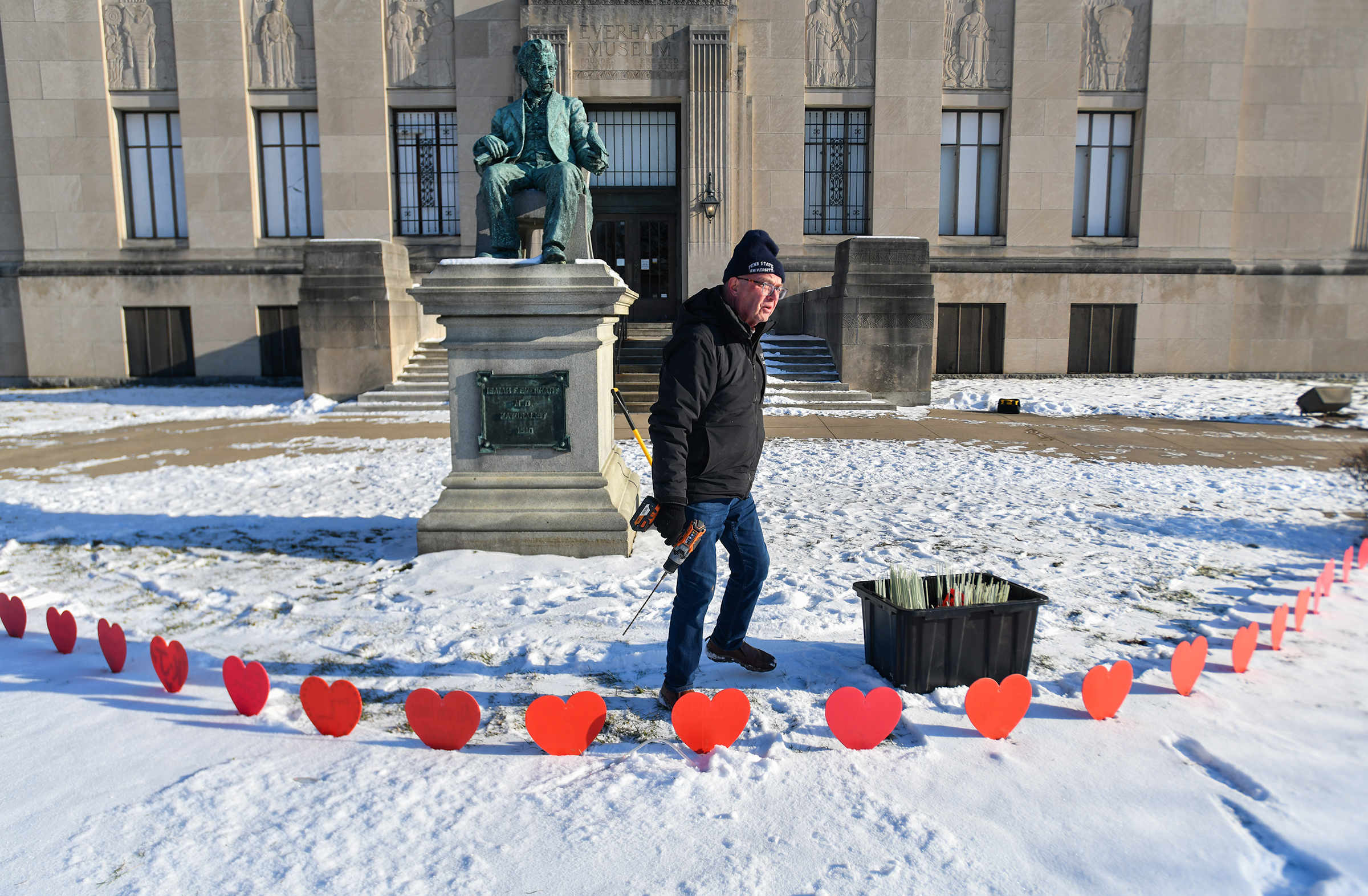 Scranton resident Frank Dubas installs hearts inscribed with names and...
