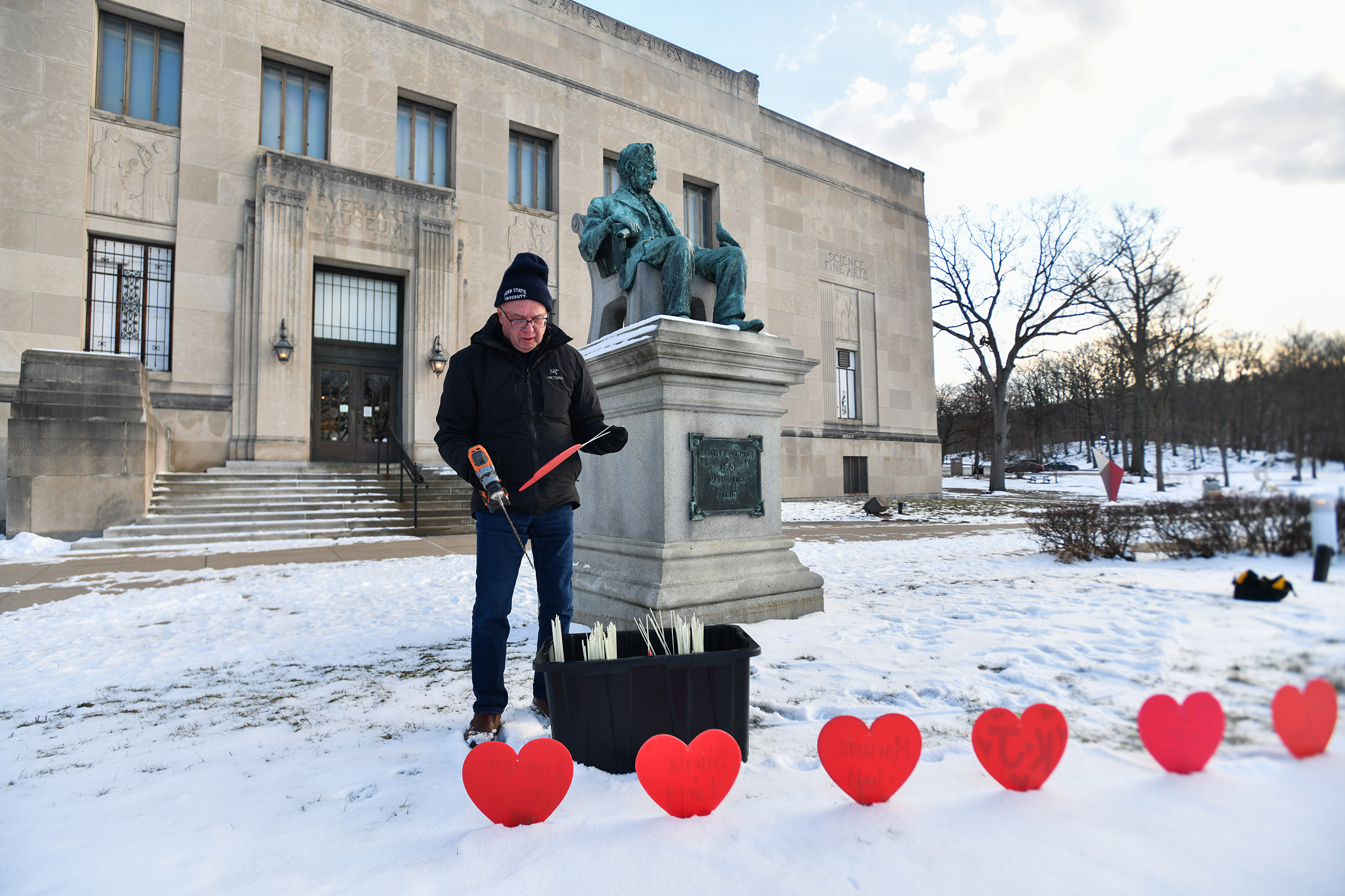 Scranton resident Frank Dubas installs hearts inscribed with names and...