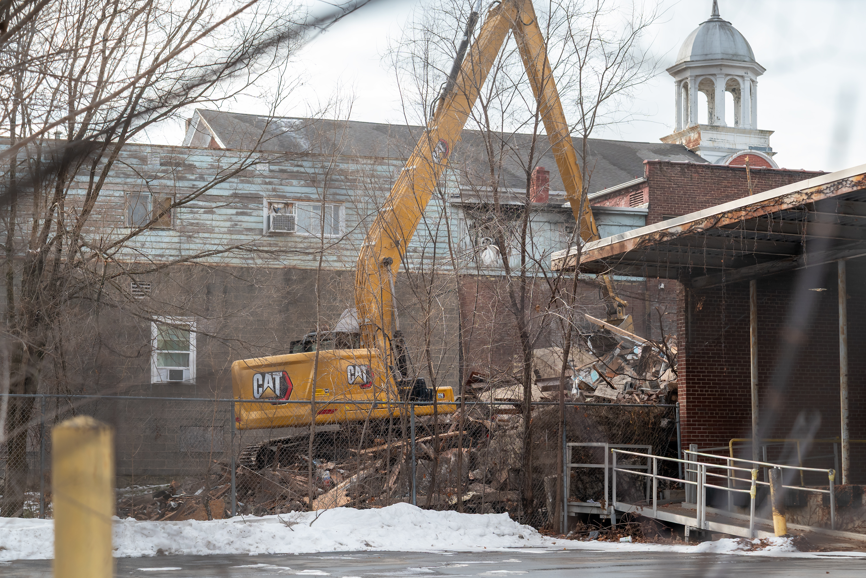 Crews work on razing a portion of the West Scranton...