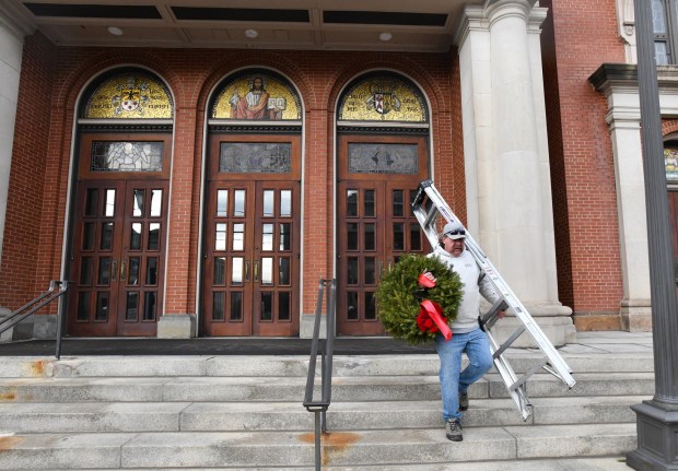 Owner of Ebb's Creative Landscape Designs Ben Barziloski takes down Christmas decorations from St. Peter's Cathedral in Scranton Monday, January 12, 2026. (SEAN MCKEAG / STAFF PHOTOGRAPHER)