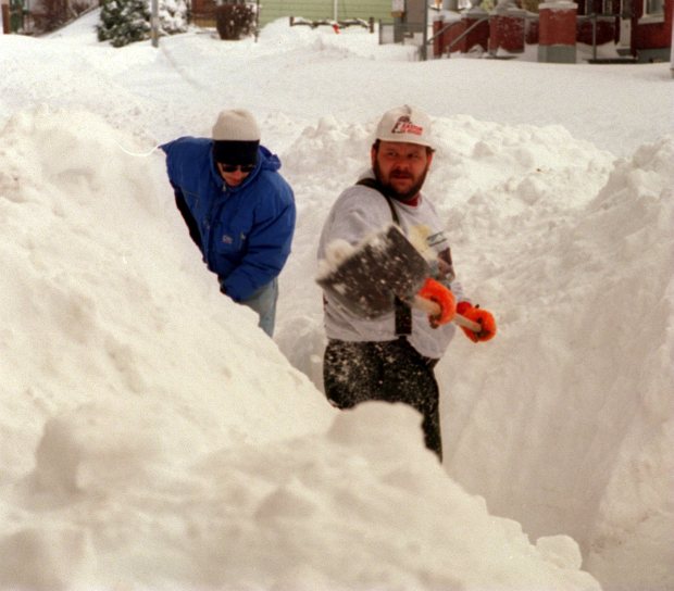 Neighbors Carmen Lisinicchia, left, and Tom Howey dig a path in the snow in front of their homes in the 200 block of West Berwick Street on Easton's South Side after the blizzard of 1996, Jan. 8, 1996. (Ed Koskey Jr./The Morning Call)