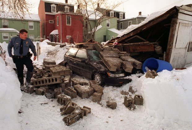 Phillipsburg patrolman Robert Schmeltzly looks over a garage collapse on South Main Street after the blizzard of 1996, Jan. 9, 1996. (Pete Shaheen/The Morning Call)