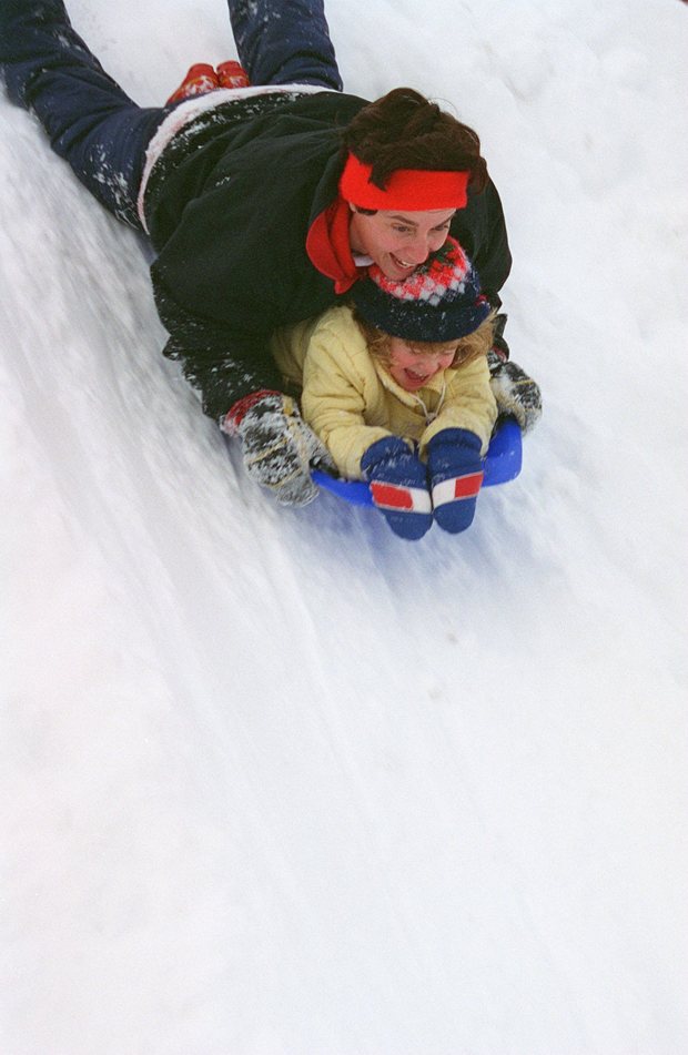 Evelyn Costelloe and her daughter Mary, 4, both of Emmaus, sled down a huge pile of snow left by snowplows in the Rodale Press parking lot on North Sixth Street in Emmaus after the blizzard of 1996. (Betty E. Cauler/The Morning Call)
