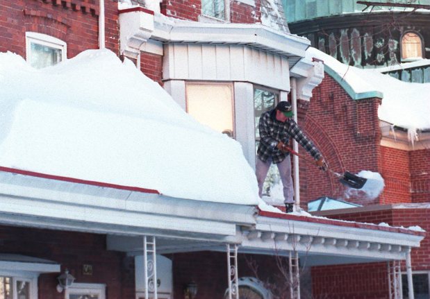 Hugh O'Donell shovels snow off the roof of his house on Fullerton Avenue after the blizzard of 1996, Jan. 8, 1996. (John C. Anderson/The Morning Call)