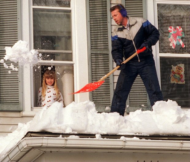 It was fun for Brittany Dechine, 5, to watch her dad Steve Dechine working for several hours shoveling snow from atop a second floor roof on their home and a neighbor's roof in the 1400 block of Butler Street in Easton, after the blizzard of 1996, Jan. 14, 1996. (Ed Koskey Jr./The Morning Call)
