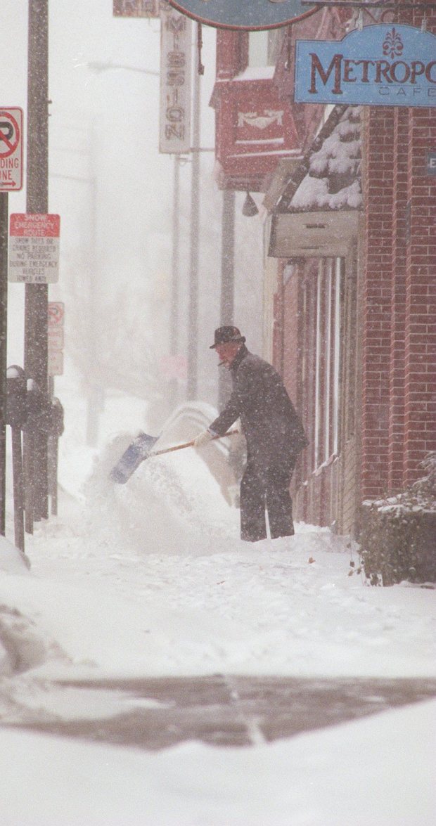 Ed Molchany shovels as more snow swirls around him on the 300 block of Hamilton Street during the blizzard of 1996, Jan. 7, 1996. (John C. Anderson/The Morning Call)