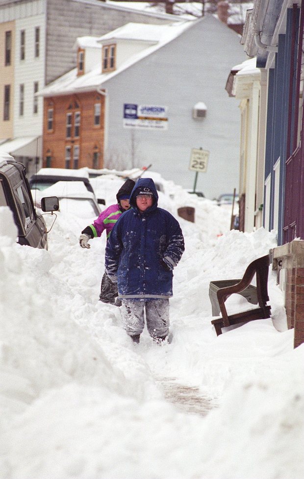 Michael Malchon, 11, of Lansford, followed by his friend Patrick Kennedy, 10, of Summit Hill, walk down Broadway in Jim Thorpe after the blizzard of 1996, Jan. 10, 1996. (Catherine Meredith)