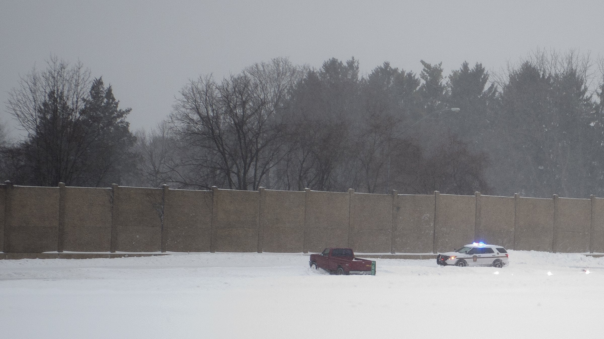 Pennsylvania State Police attend to a vehicle off the road...