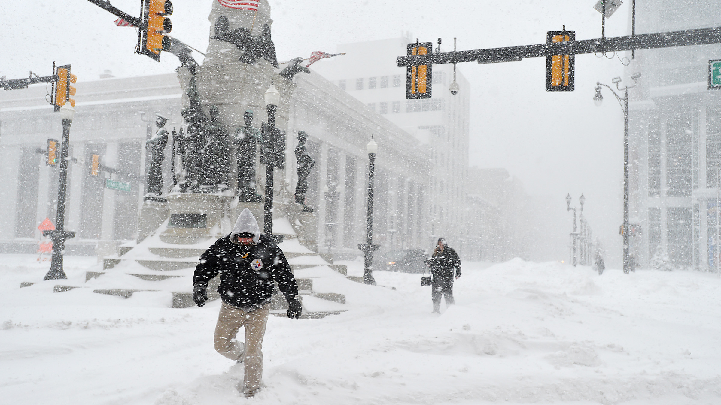 People try to cross snow drifts at Seventh and Hamilton...