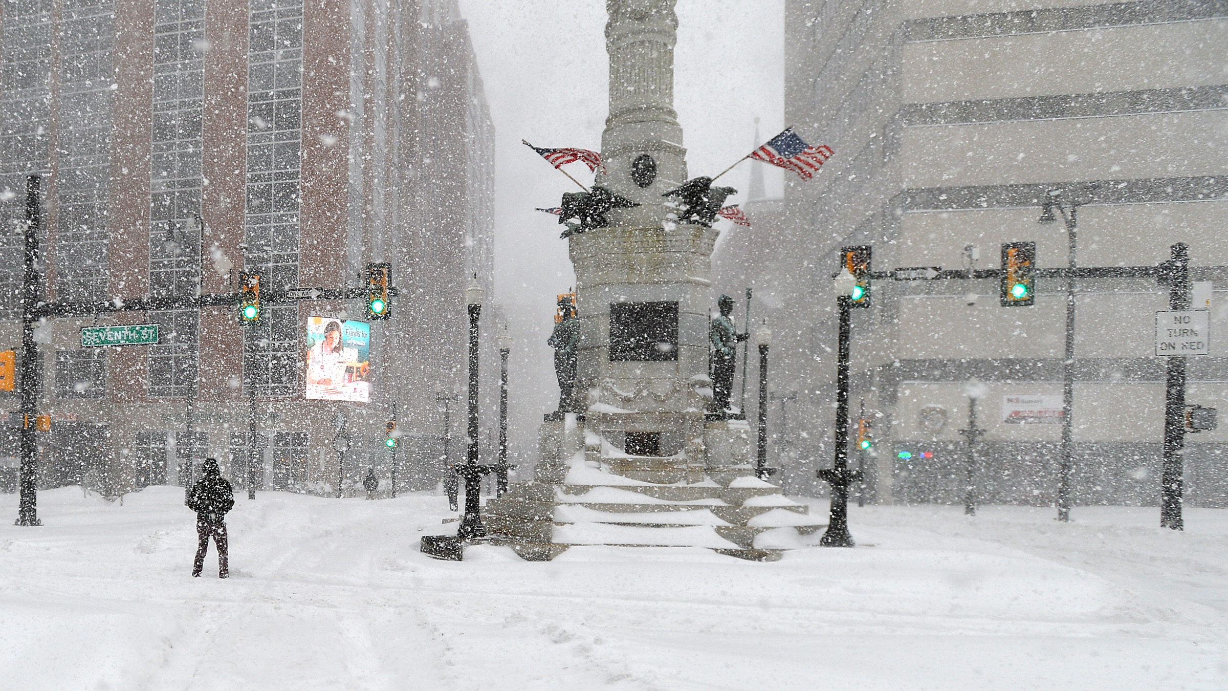 People try to cross snow drifts at Seventh and Hamilton...