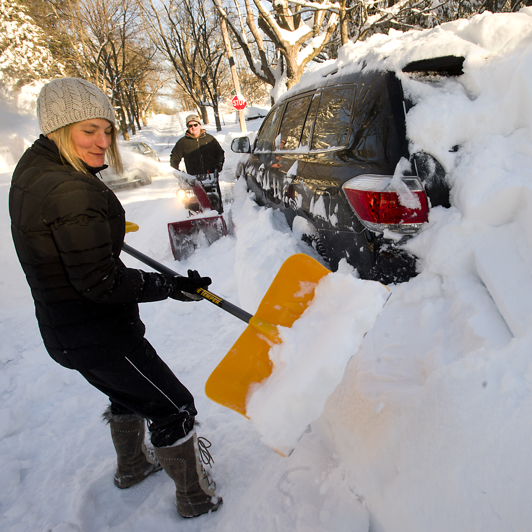 Jan Saeger digs out her car along North Glenwood Street...