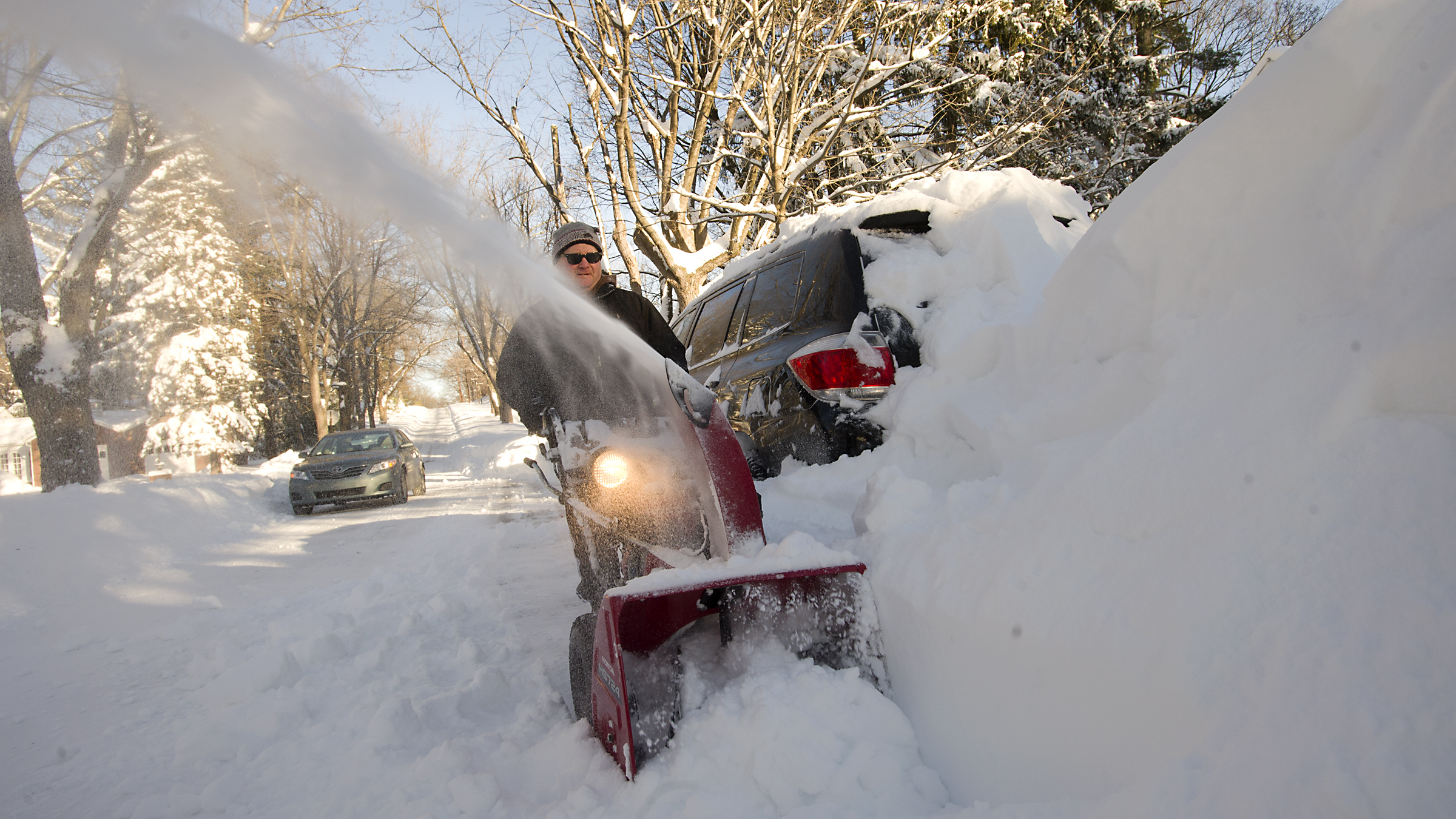Kurt Saeger uses a snowblower along North Glenwood Street in...